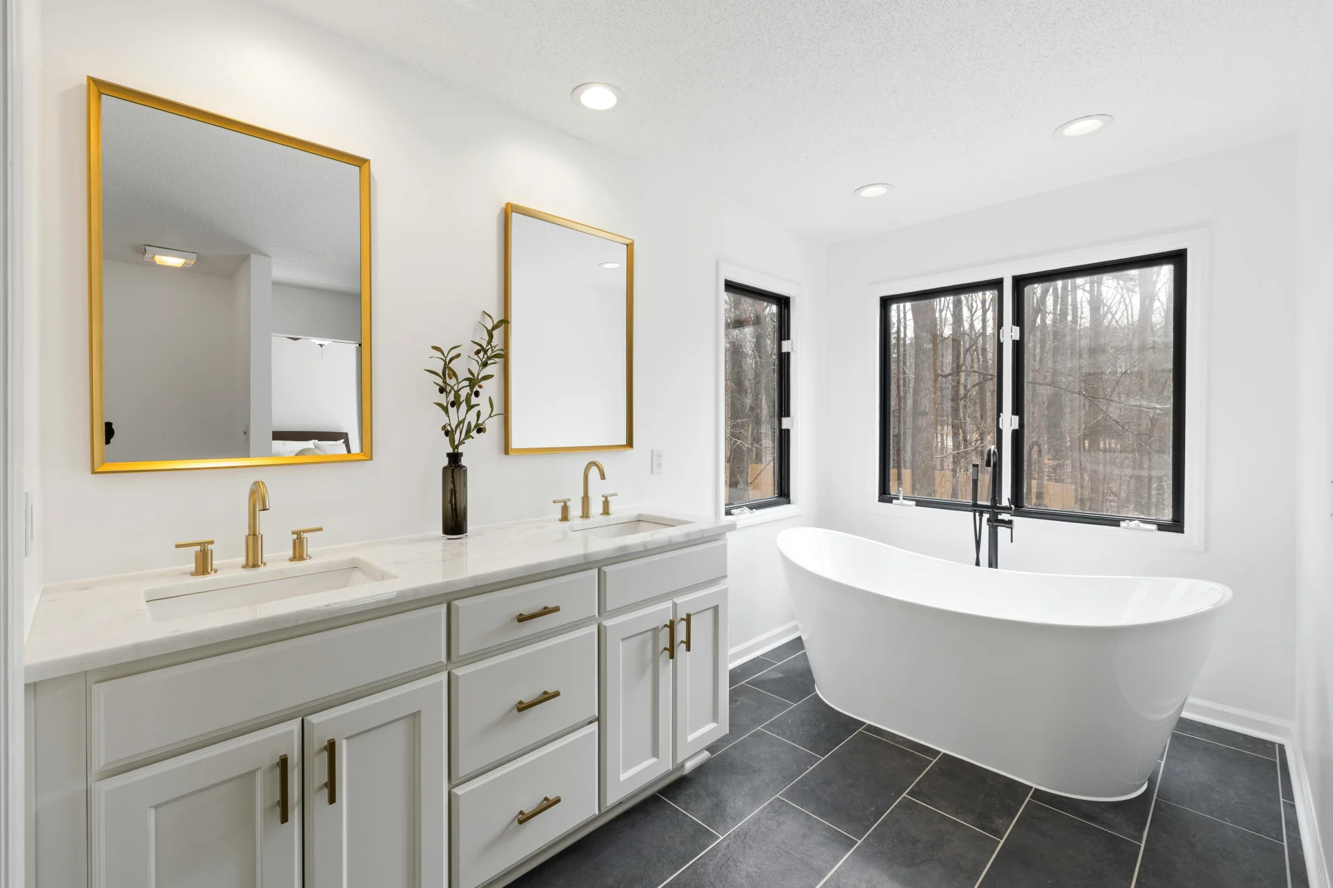 Copp Constuct Design showroom Raleigh NC bathroom remodel with dark gray large tiles and light gray double vanity