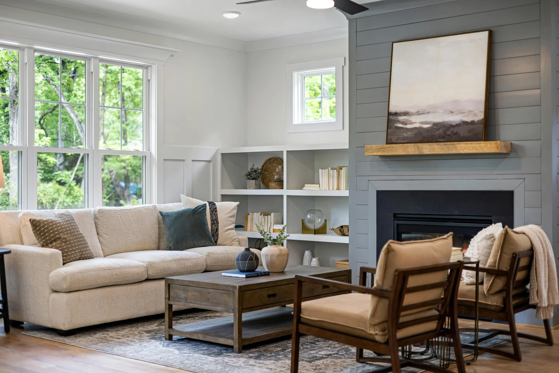 living room with dark gray shiplap fireplace wall