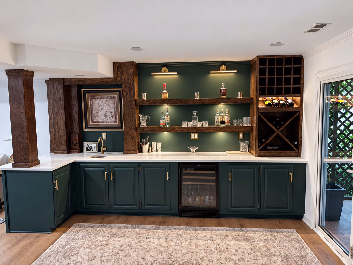 Finished Five Points home bar with deep green cabinets, handcrafted wood shelving and wine racks.