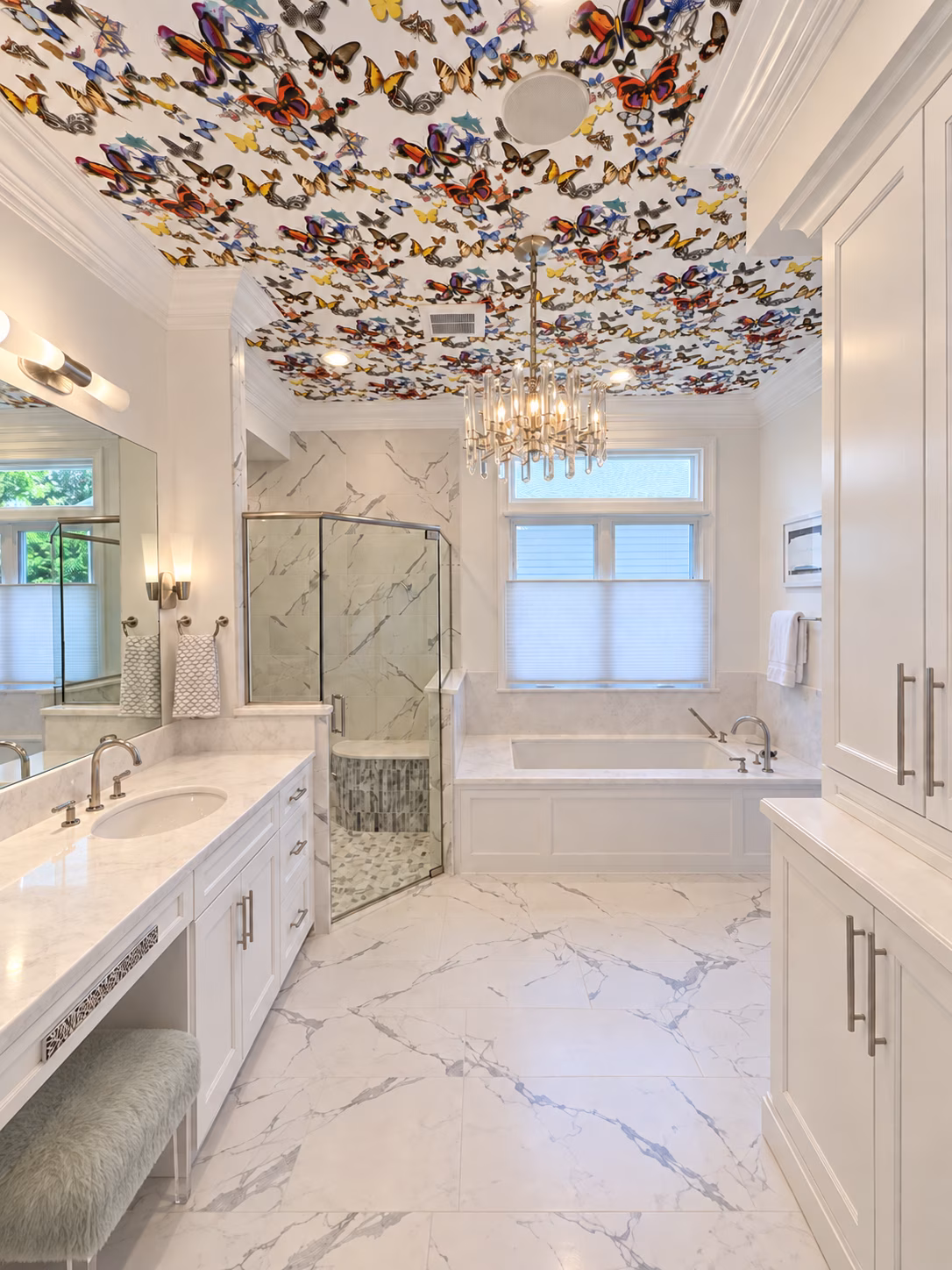 Completed Lassiter Mill, Raleigh bathroom with butterfly ceiling, crystal chandelier, white cabinetry and built-in tub.