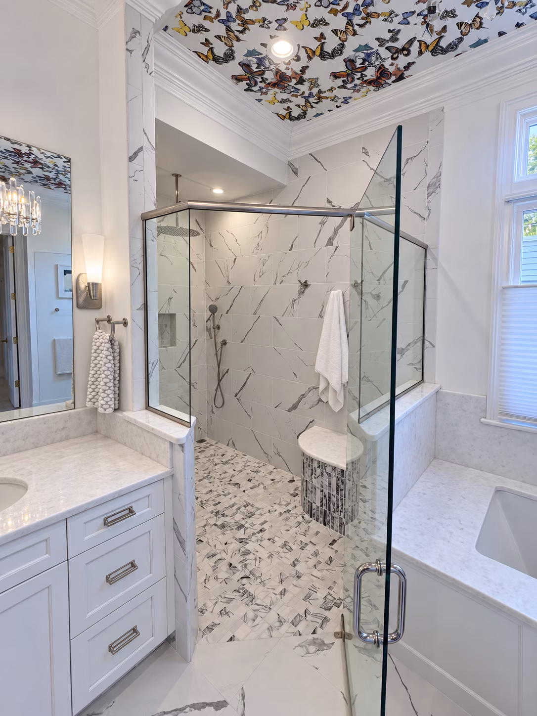 shower-detail-retouched Lassiter Mill bathroom shower with veined wall tile, mosaic floor and curved corner bench.